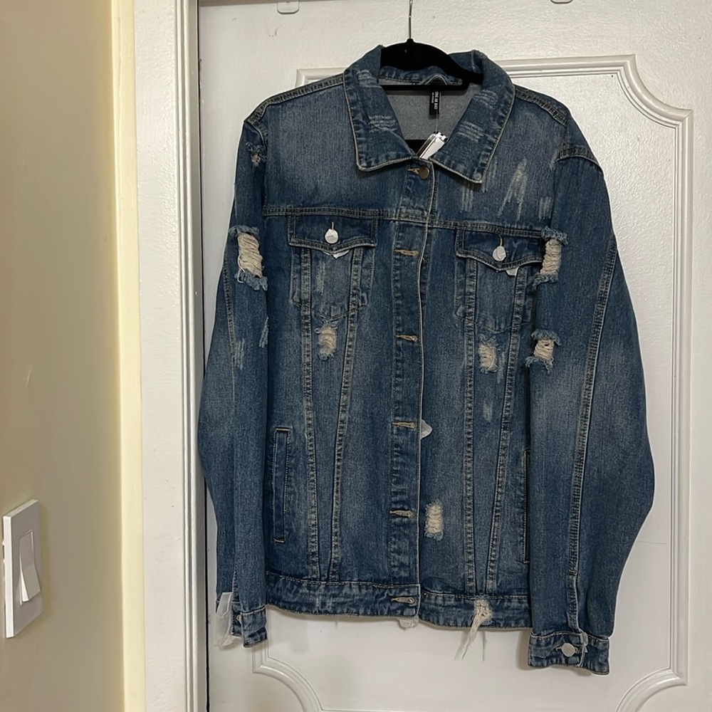 Distressed denim jacket NWT with patches on the back